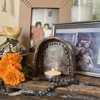 a table with pictures and a candle on it